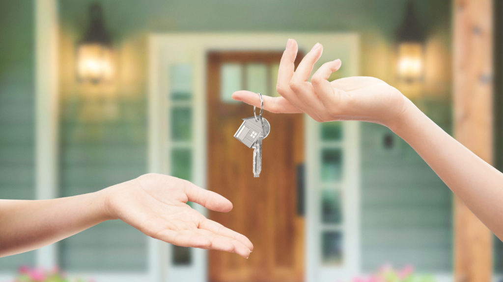 new home with key being exchanged